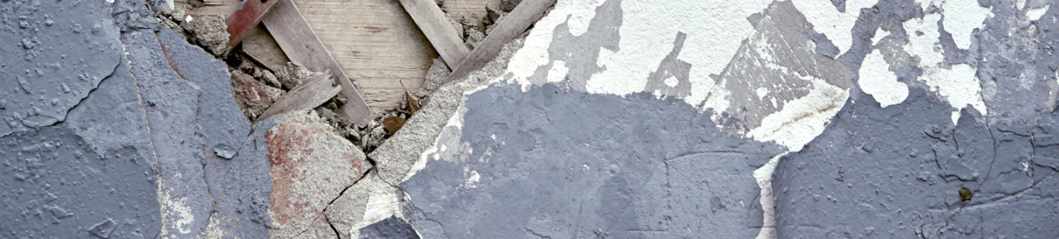 A dilapidated wall which has a missing section