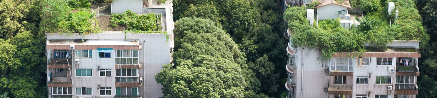 Apartment complex with greenery on the roof