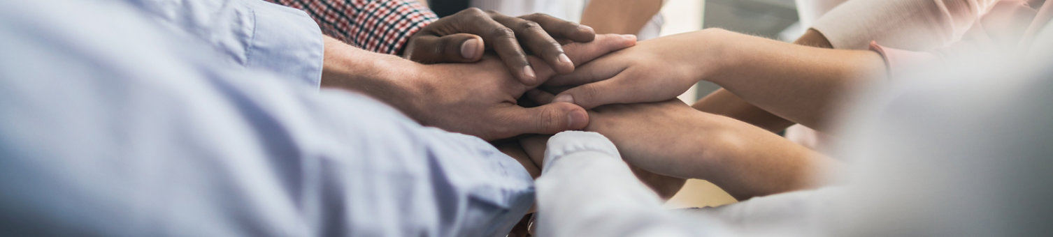 Close up view of young business people putting their hands together. Stack of hands. Unity and teamwork concept.; Shutterstock ID 1517975135; Purchase Order: n/a; Job: RICS_Brand library_Content team