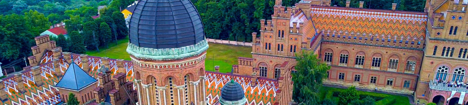 Aerial view of the Seminary Residence and the Church of the Three Saints. UNESCO. architecture. Old historical university building with towers, domes and green garden Chernivtsi, Ukraine 