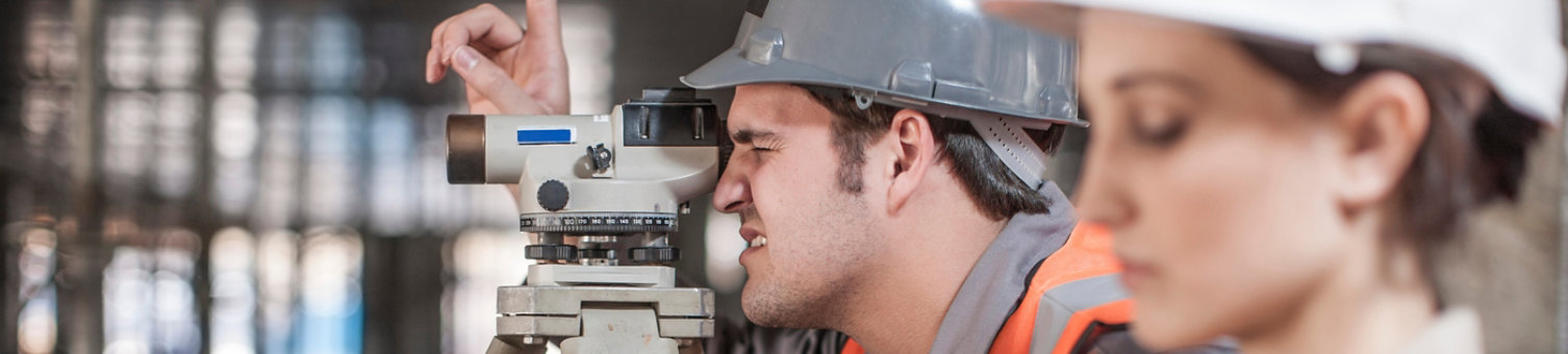 2 construction workers surveying
