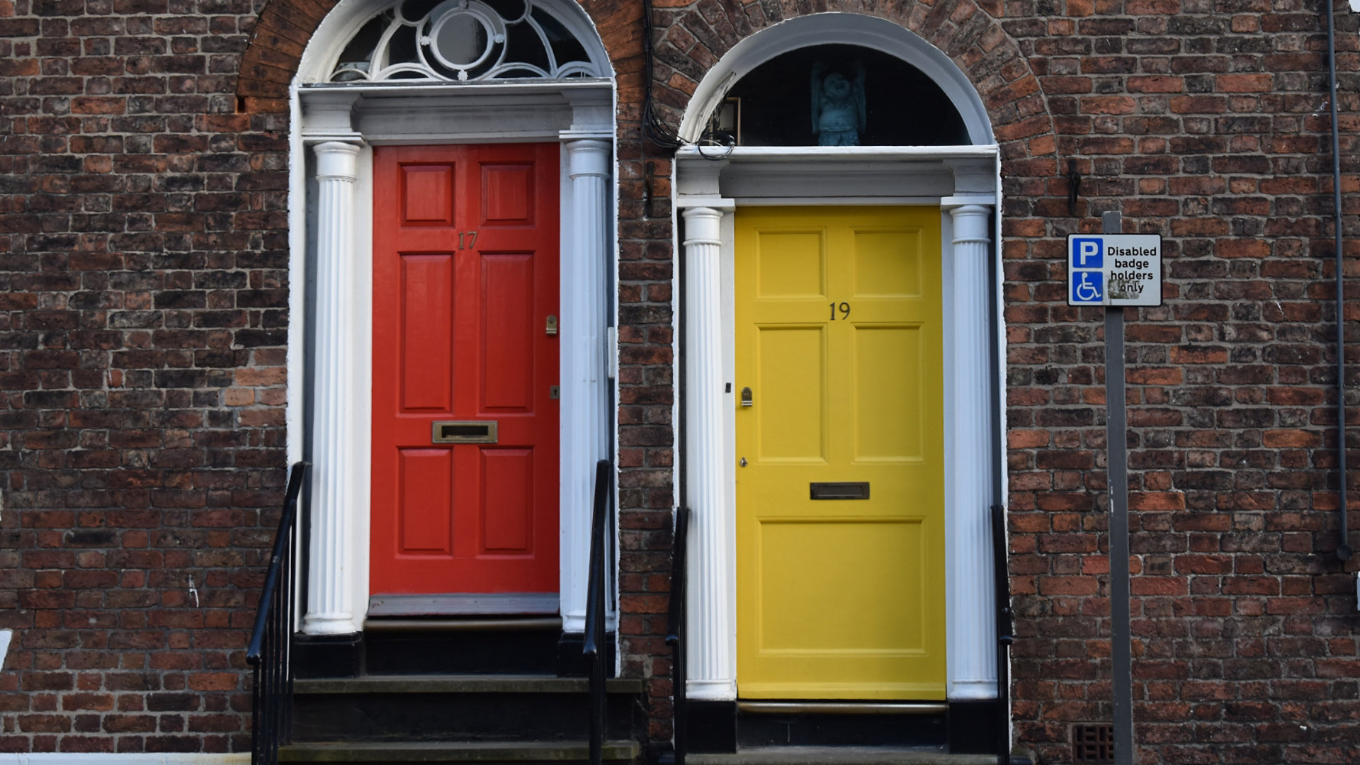 Two brightly coloured front doors of residential properties