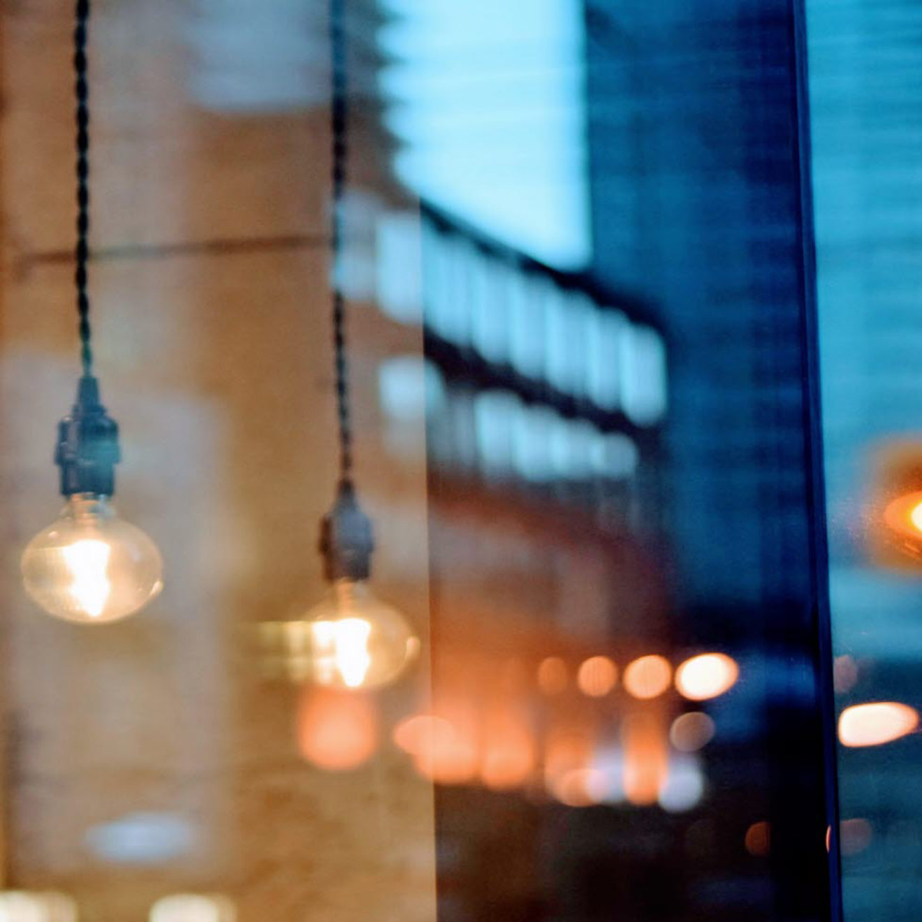 Light bulbs hanging against a glass mirror background