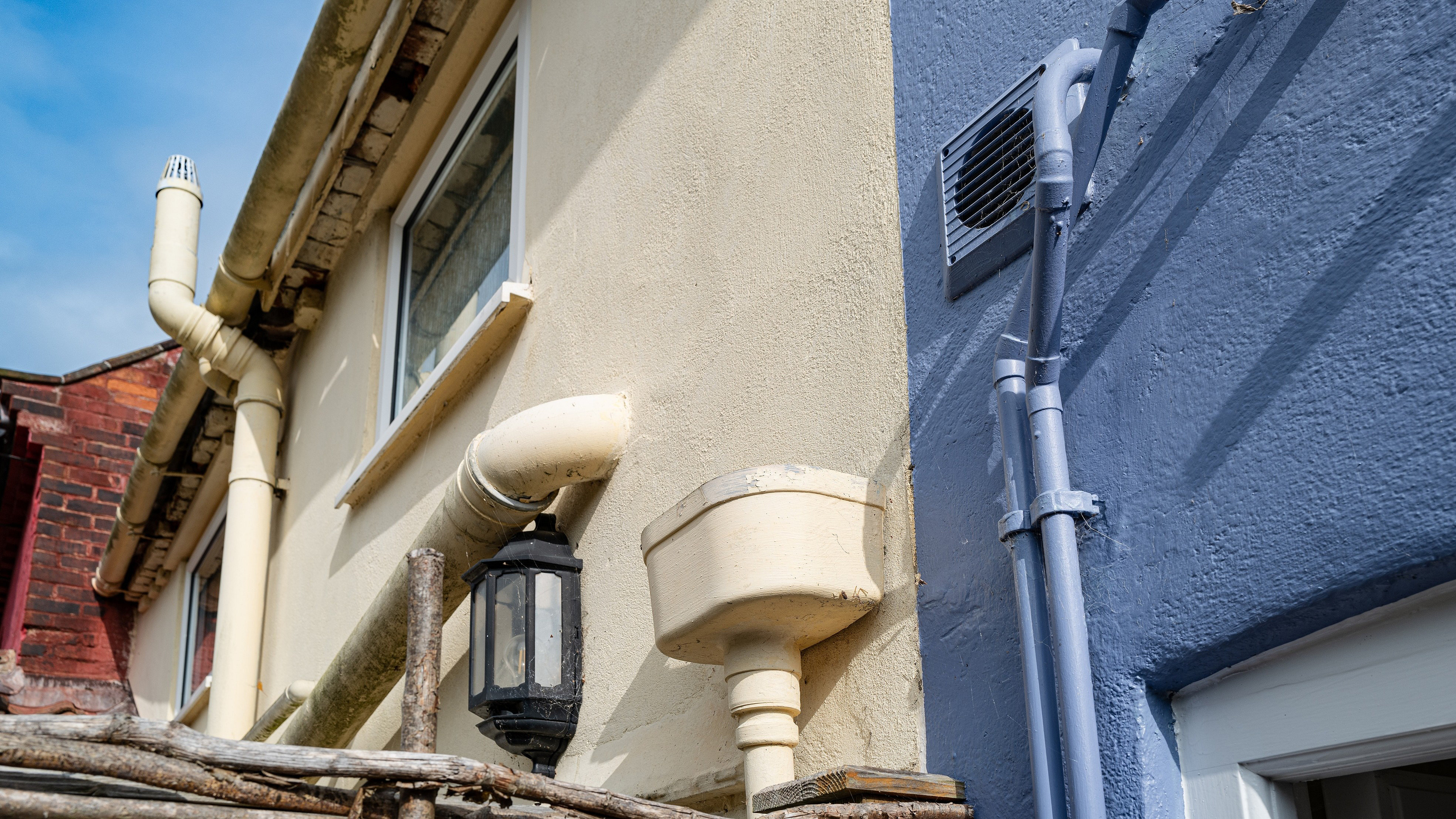 Back garden view of terraced houses, now used as holiday lets showing the painted walls