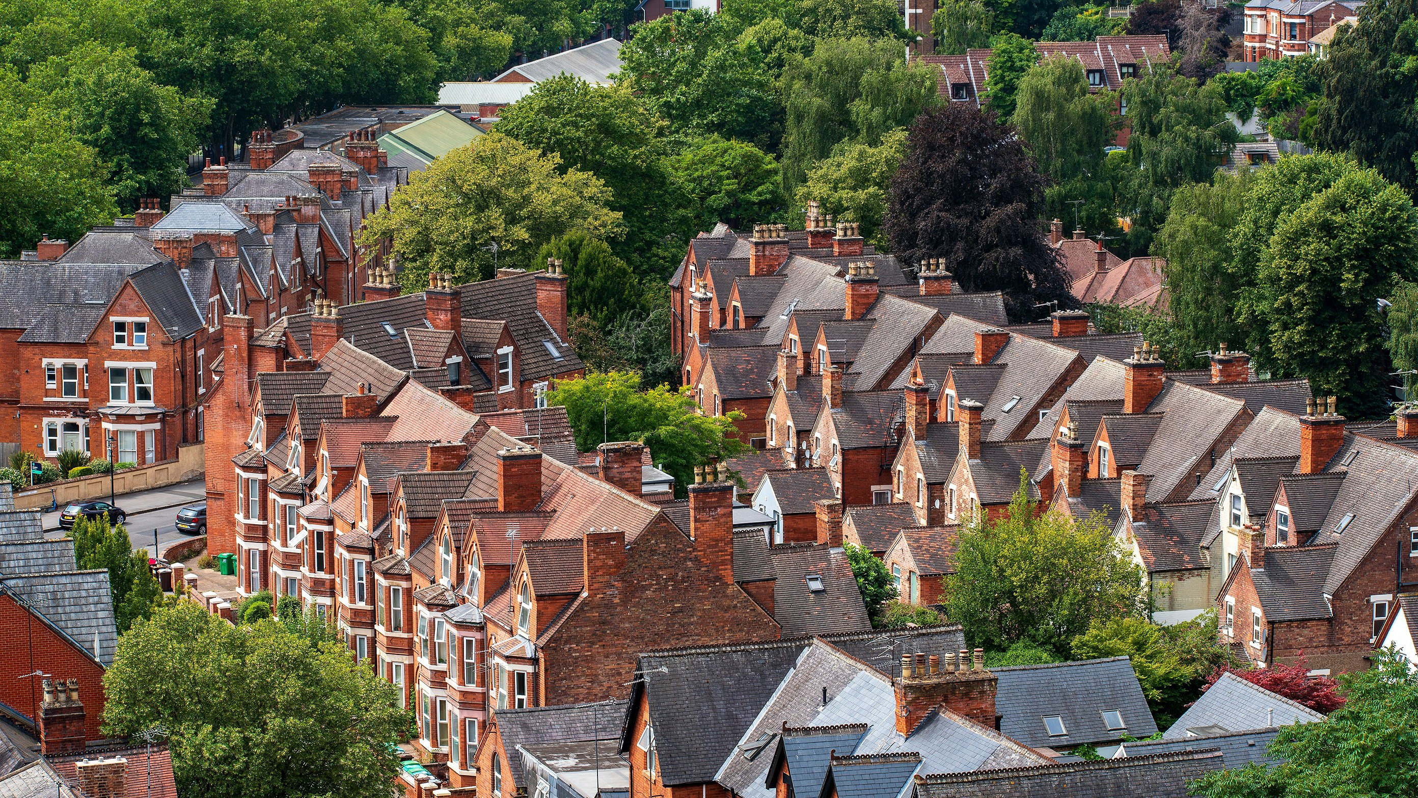 Elevated view across the historic Park Estate in Nottingham, England, as seen from the grounds of Nottingham Castle. The scene showcases elegant residential architecture, mature tree-lined streets, and the distinctive urban landscape of one of Nottingham's most prestigious conservation areas, blending heritage, greenery, and city character.