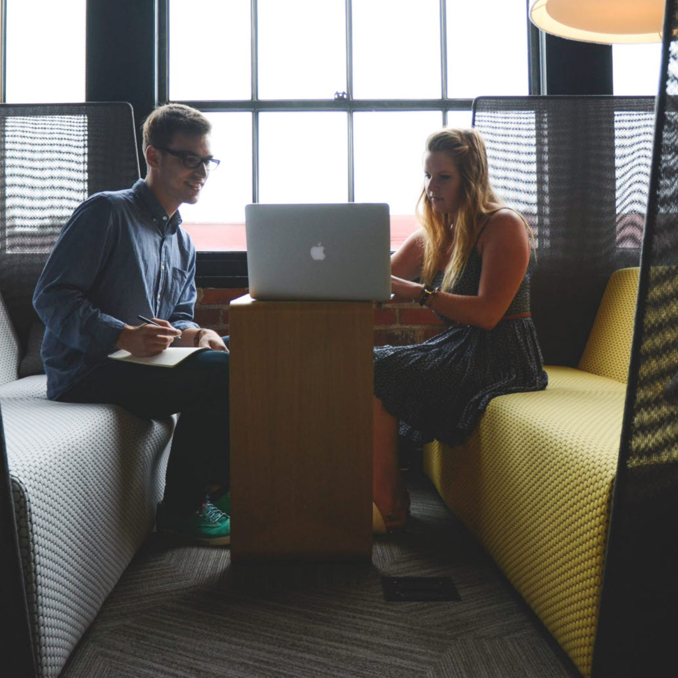 A group of professionals sitting at a table in a meeting space