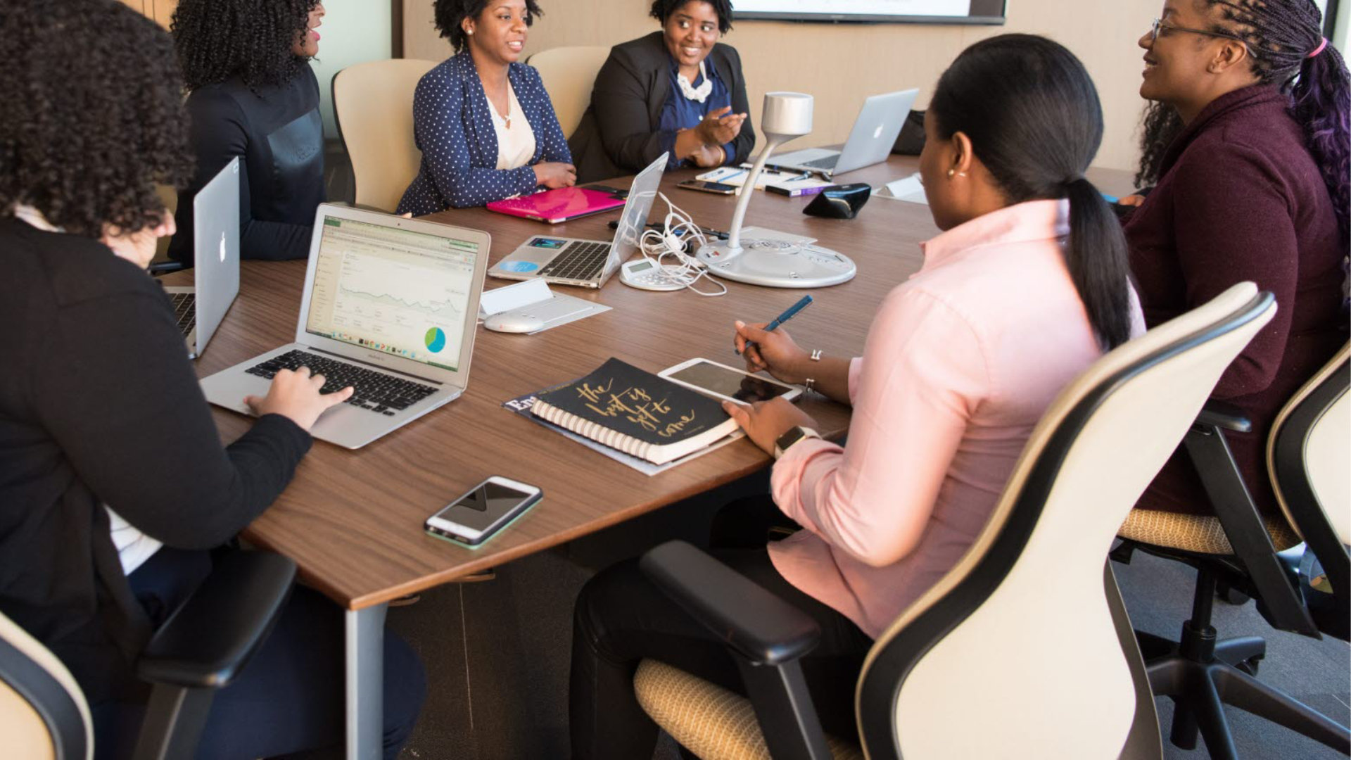 people-sitting-beside-brown-wooden-desk-near-flat