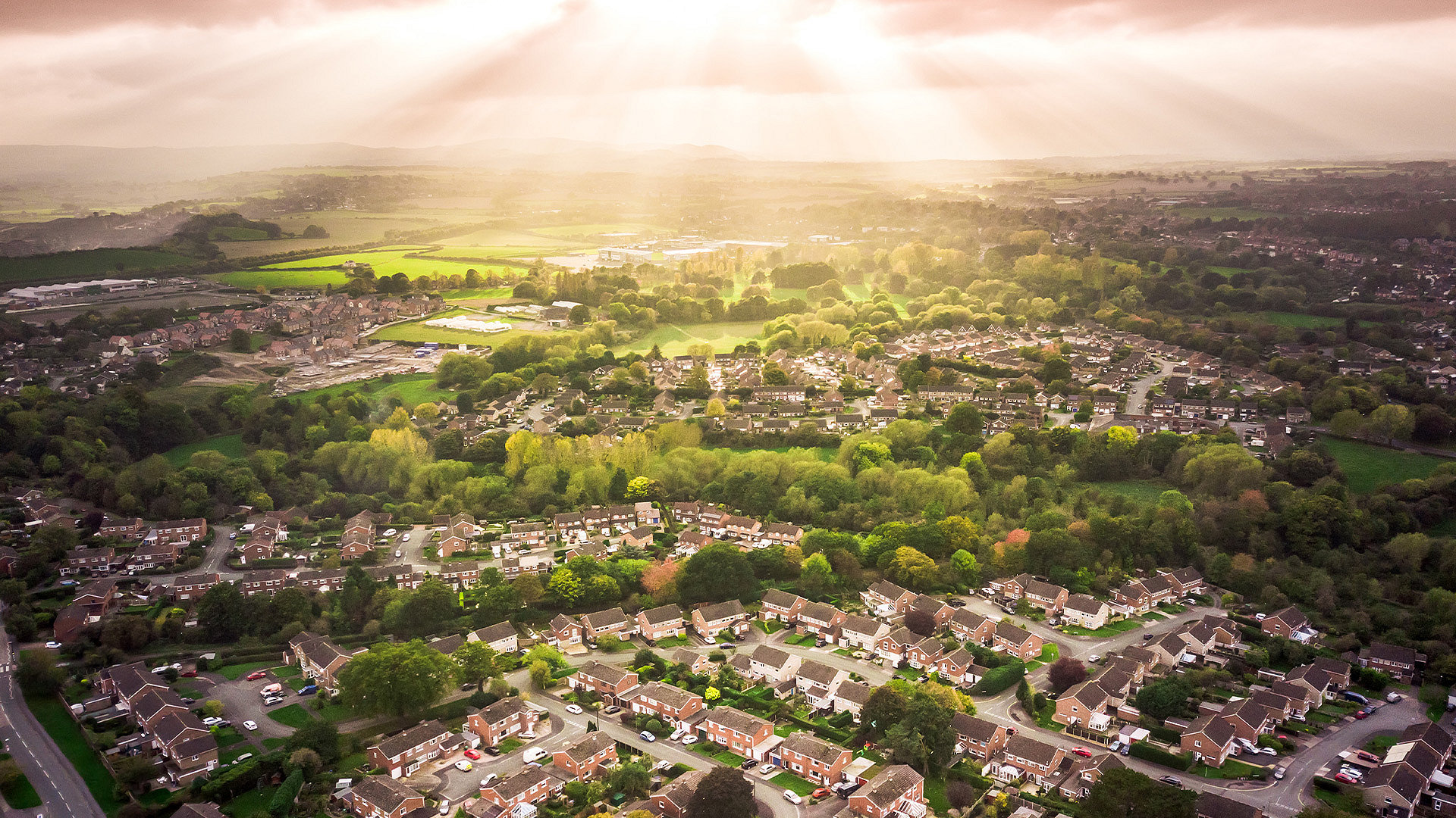 Photo of the sun over a housing estate