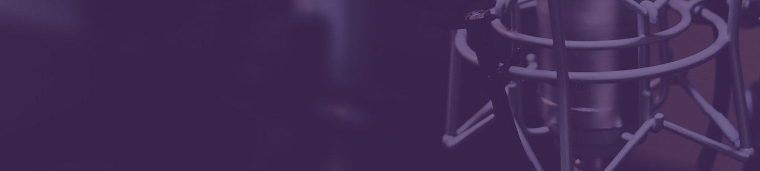 A close up of a condenser microphone in a studio. The entire image has a purple tone.