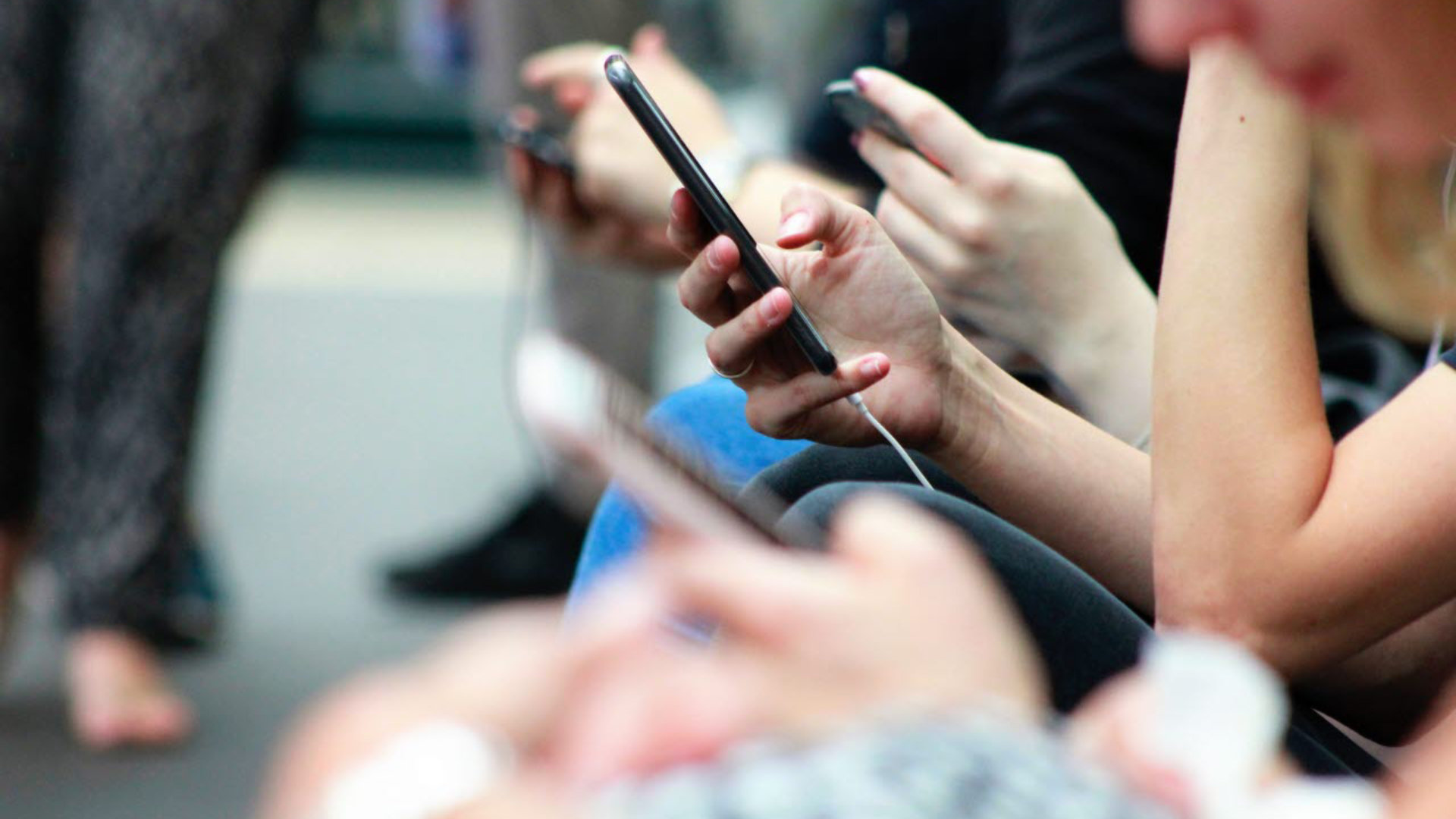 Commuters with mobile phones