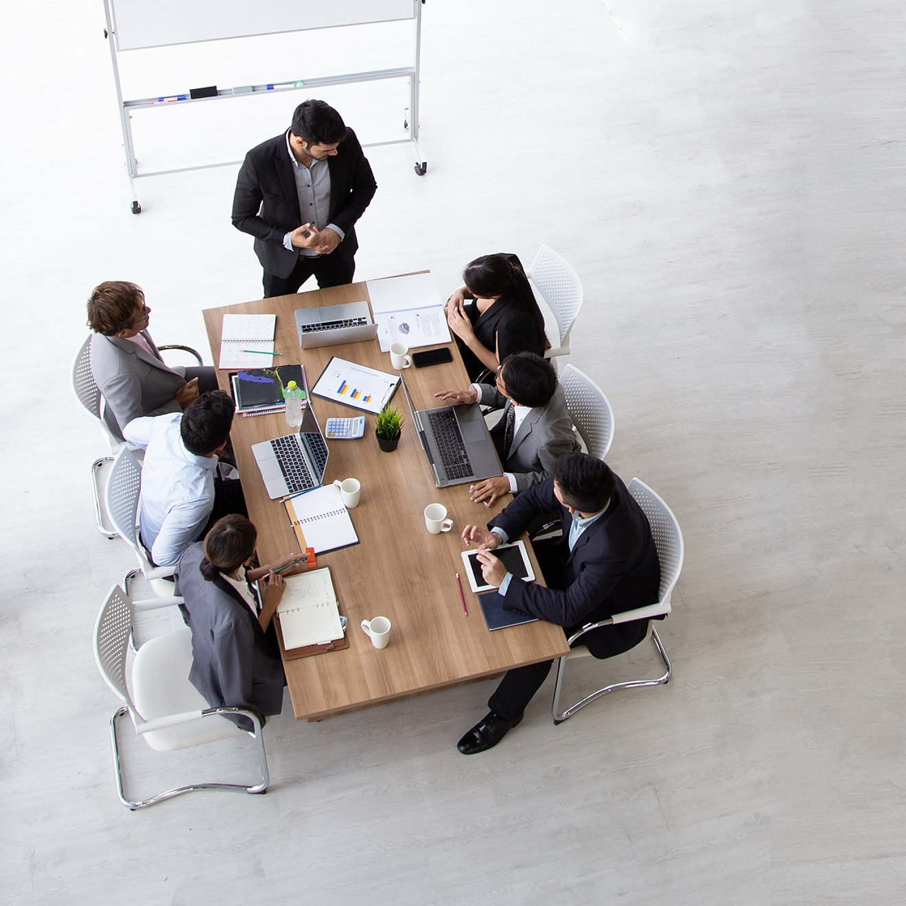 Aerial view of professionals having a discussion at a table in an open plan office space