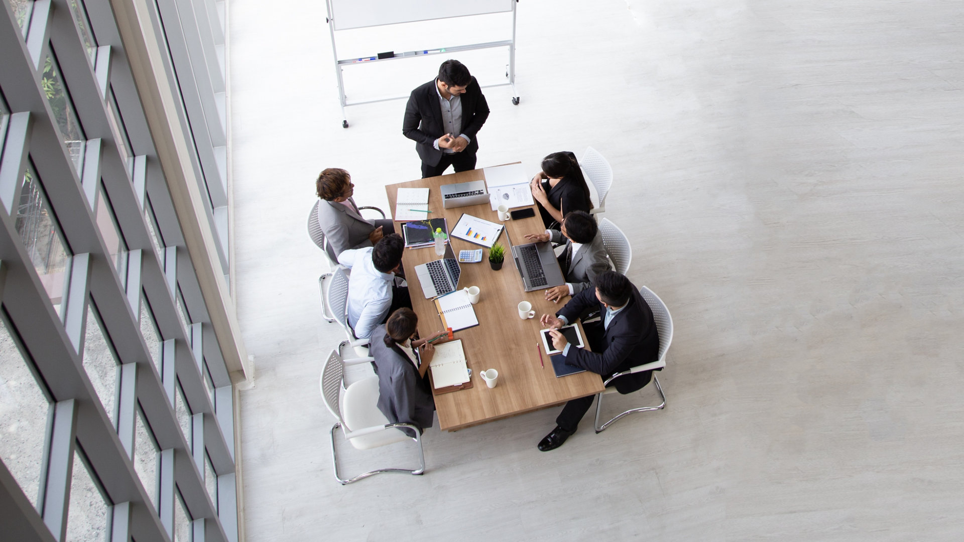 Aerial view of professionals having a discussion at a table in an open plan office space