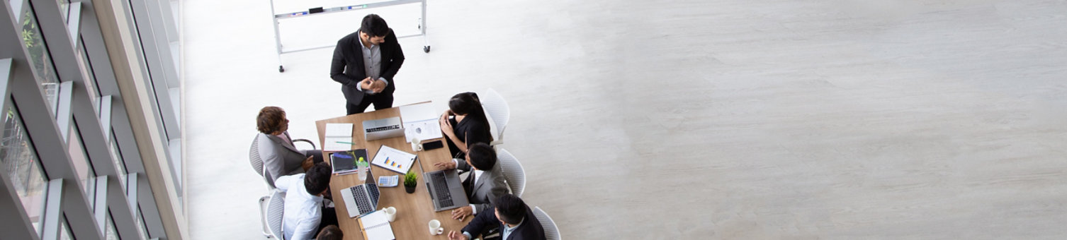 Top view of group of multiethnic busy people working in an office, Aerial view with businessman and businesswoman sitting around a conference table with blank copy space, Business meeting concept; Shutterstock ID 1478220749; purchase_order: -; job: -; client: -; other: -