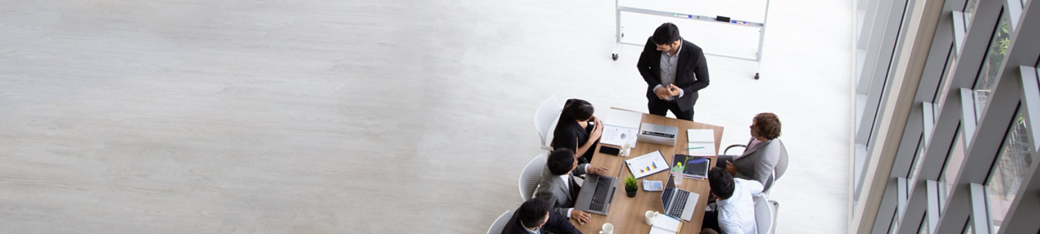 Top view of group of multiethnic busy people working in an office, Aerial view with businessman and businesswoman sitting around a conference table with blank copy space, Business meeting concept; Shutterstock ID 1478220749; purchase_order: -; job: -; client: -; other: -