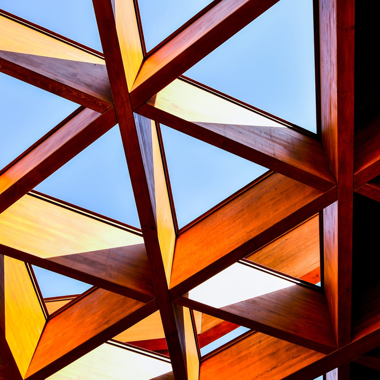 A glass roof with a red triangular framework