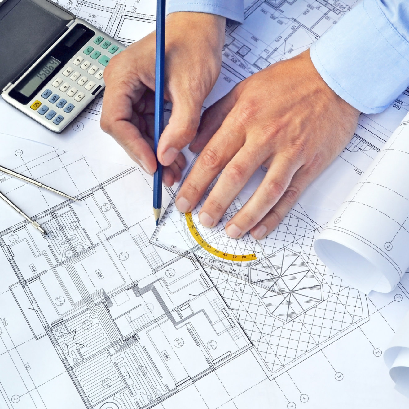 Hands with the tool on a background of project drawings; Shutterstock ID 211689319; purchase_order: -; job: -; client: -; other: -