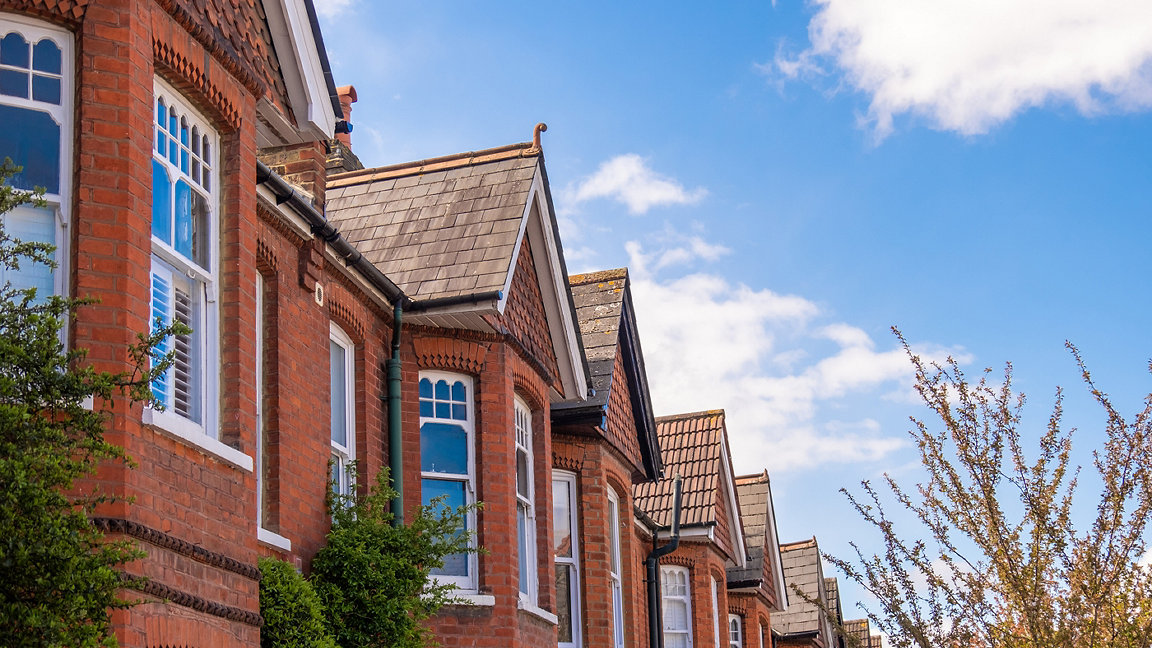 A row of typical British red brick terraced houses in West London