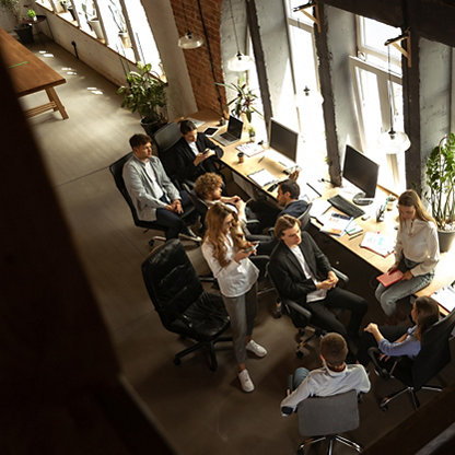 A group of young professionals relaxing and chatting in an office