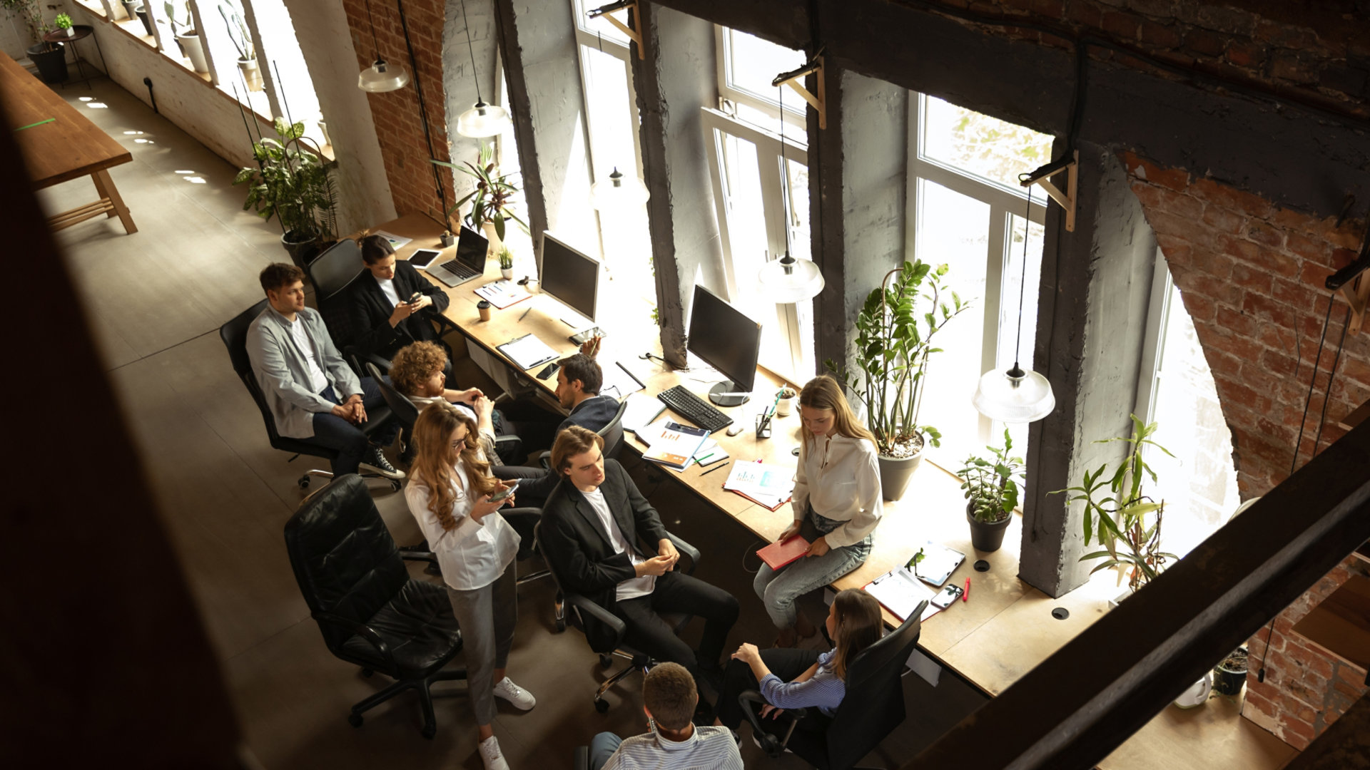 A group of young professionals relaxing and chatting in an office