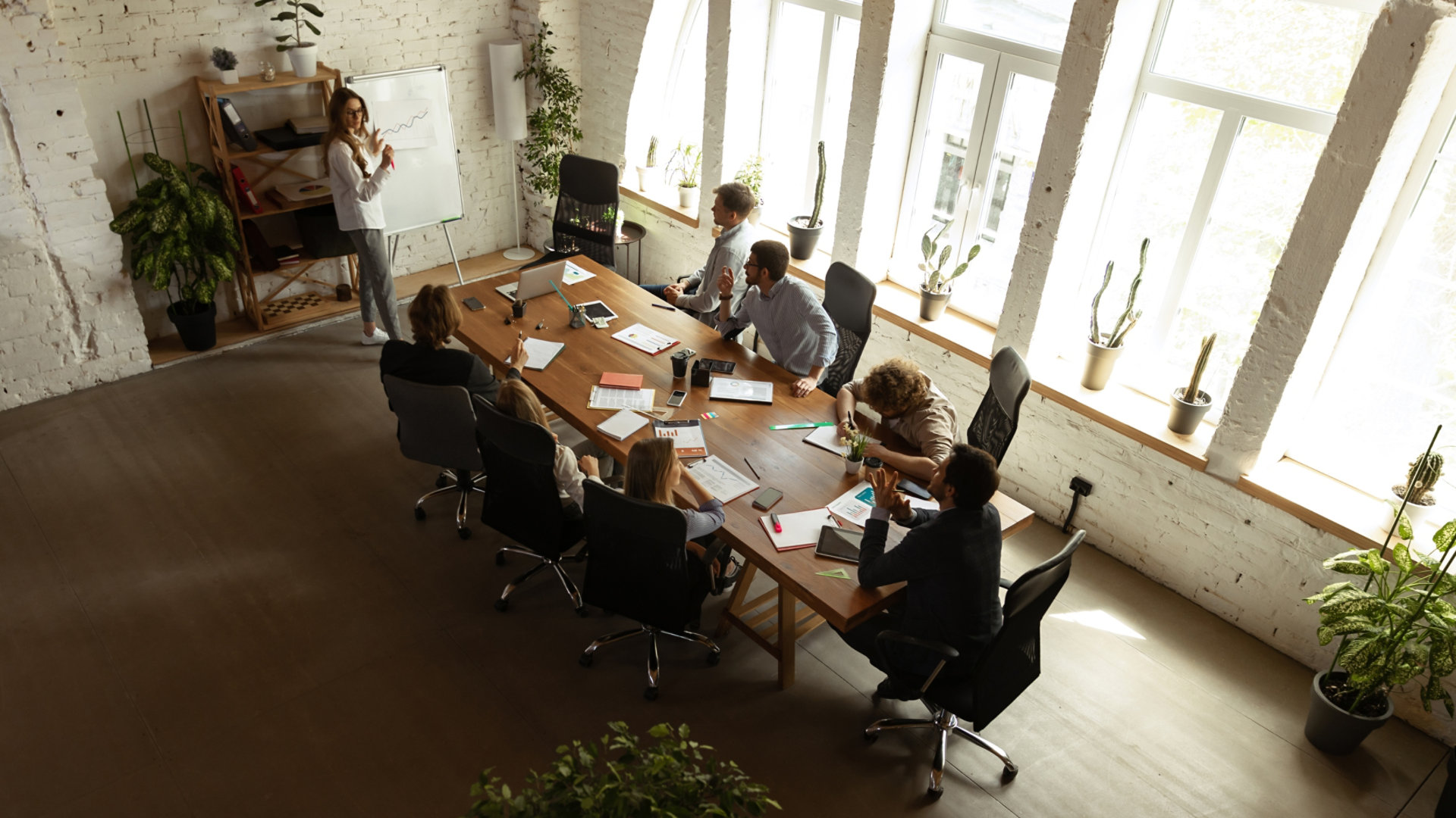 A team meeting taking place at a long desk