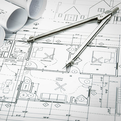 Architectural blueprints and blueprint rolls and a drawing instruments on the worktable; Shutterstock ID 246019015; purchase_order: -; job: -; client: -; other: -