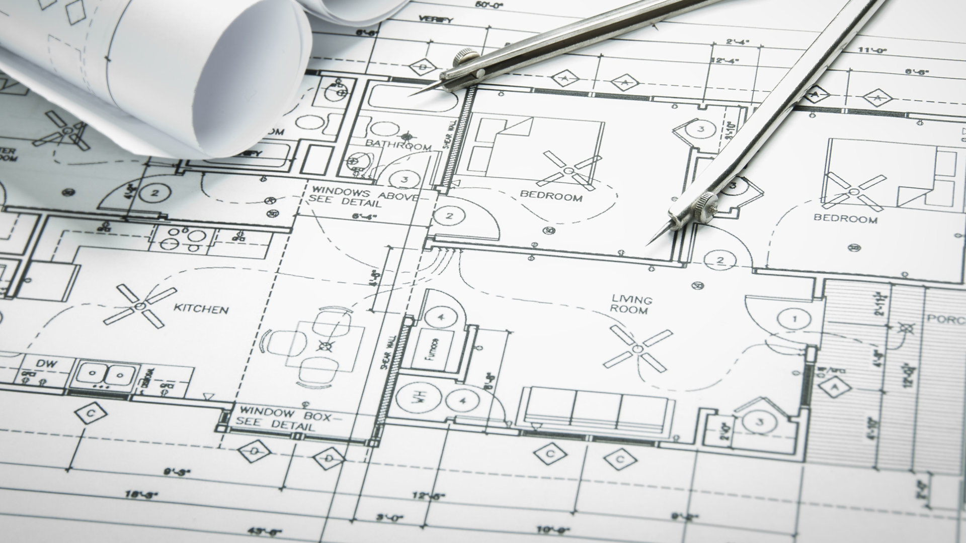 Architectural blueprints and blueprint rolls and a drawing instruments on the worktable; Shutterstock ID 246019015; purchase_order: -; job: -; client: -; other: -