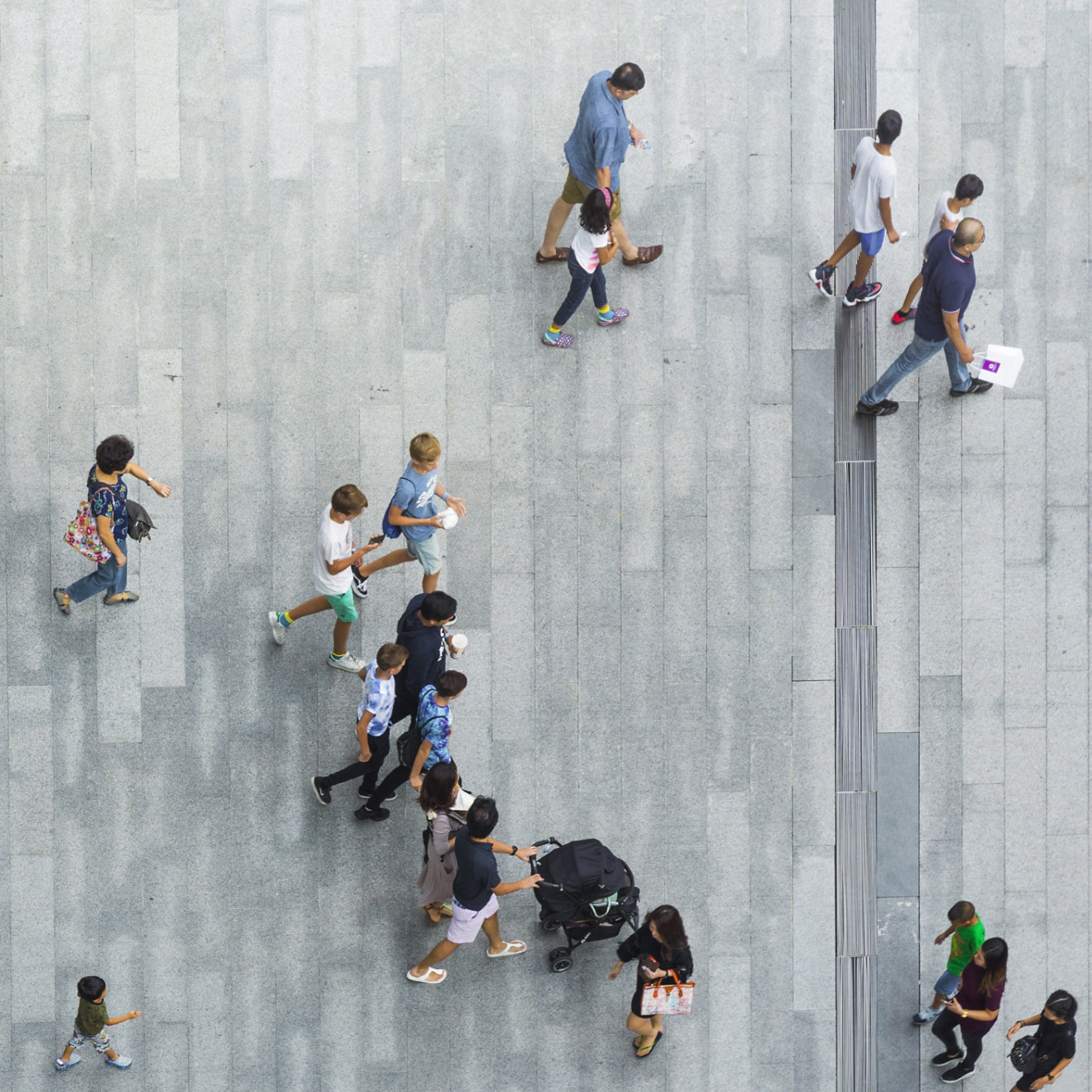 An aerial view of a people walking along the street 