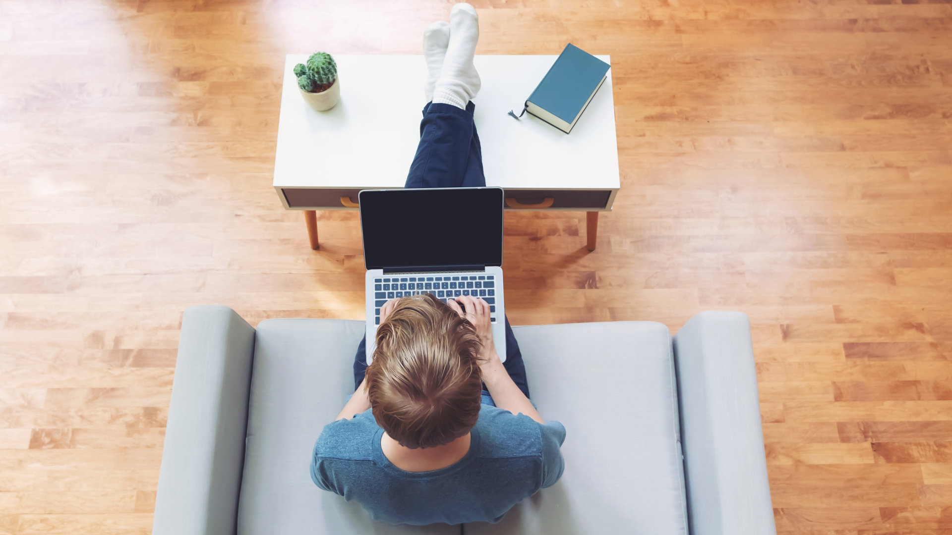 Overhead view of young blond person typing on laptop computer; Shutterstock ID 680465563; purchase_order: -; job: -; client: -; other: -