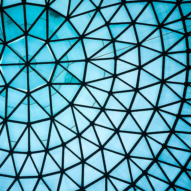 A glass dome ceiling with a radial pattern caused by the supporting framework