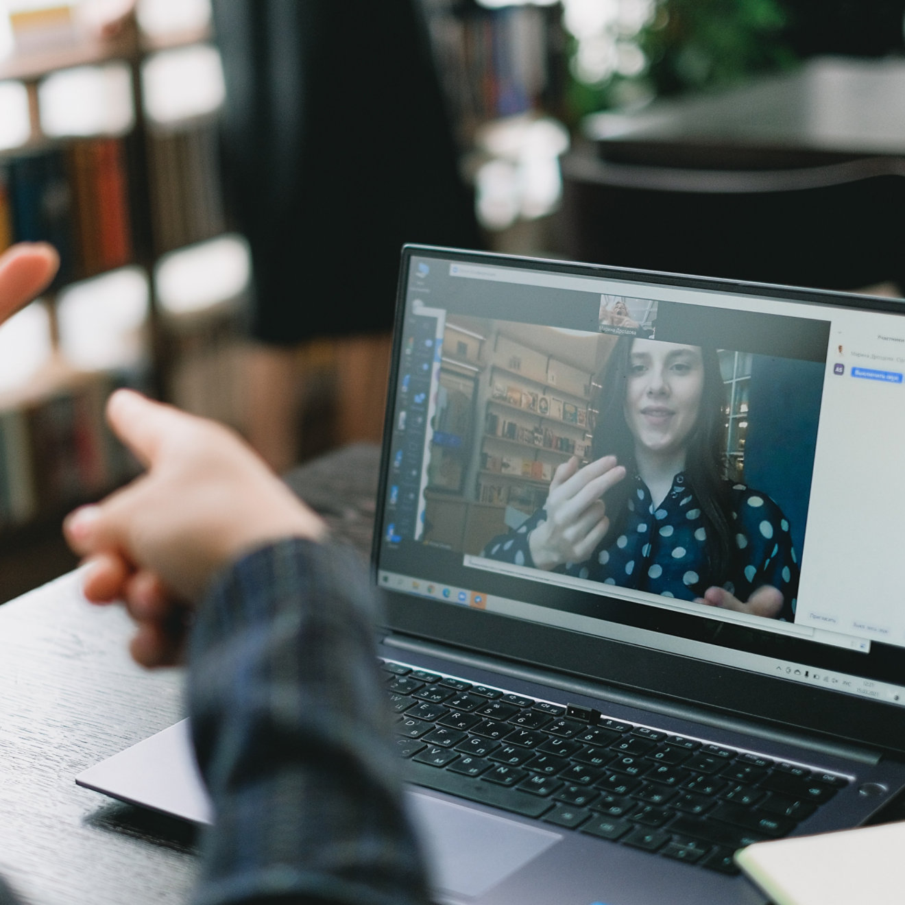 A meeting being held over video call with sign language