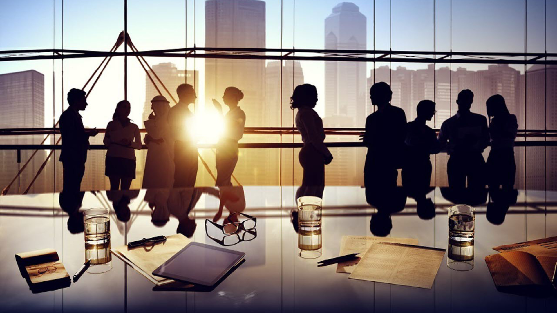 SIlhouettes of a group of people in an office