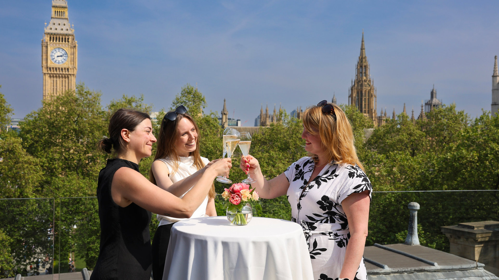 Three women raising a toast at a Surveyors House event in Westminster, London