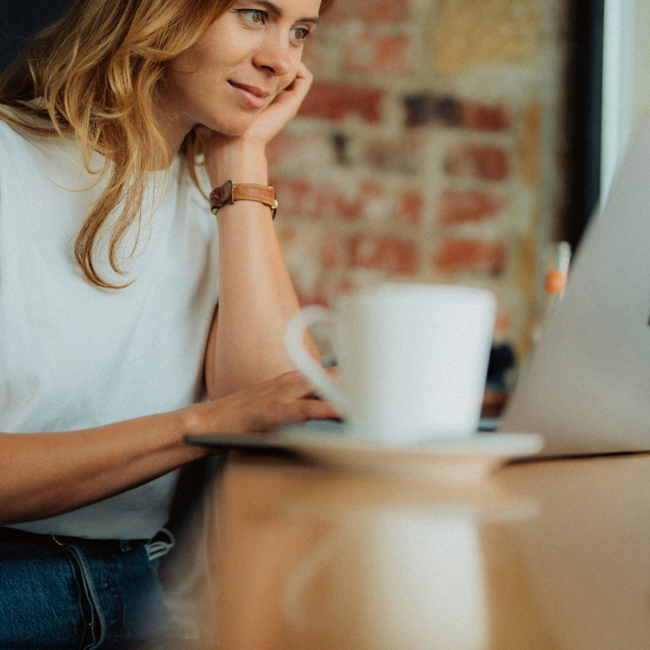 A woman looking at a laptop