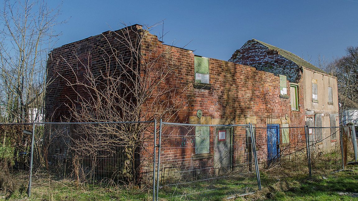 Abandoned and derelict workshop and residential house waiting for demolition