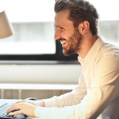 Bearded man using a computer