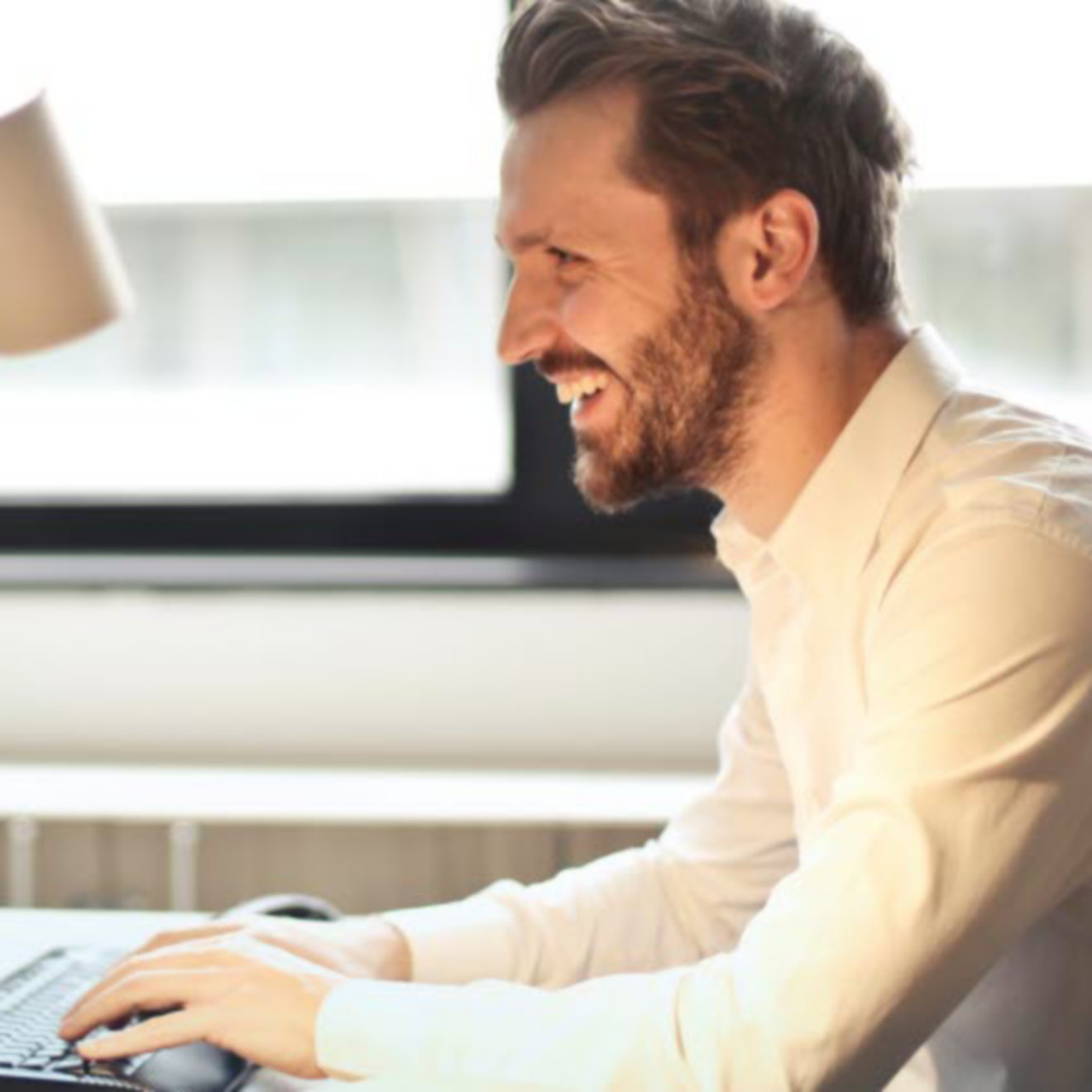 Bearded man using a computer