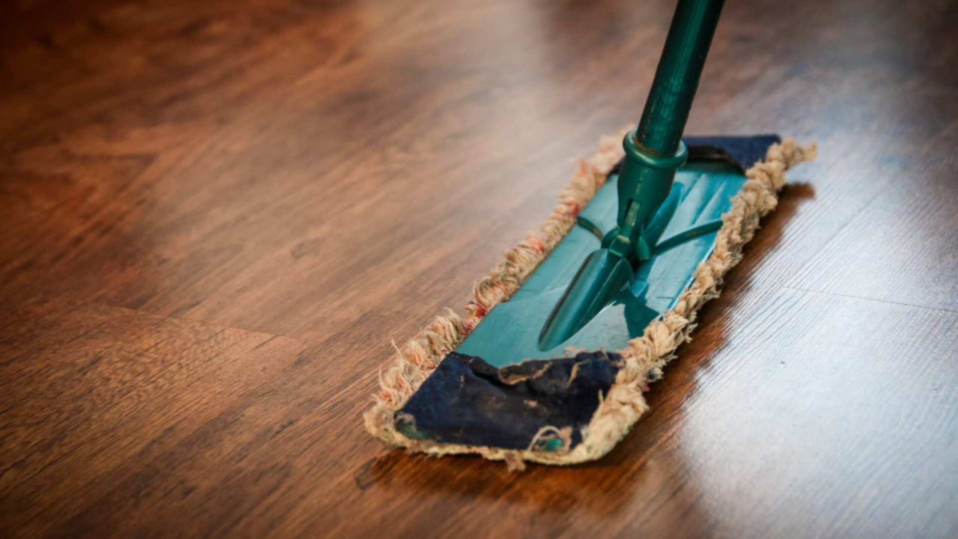 Cleaning a brown wooden floor