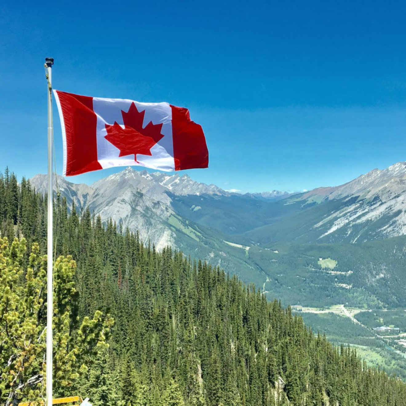 canada-flag-with-mountain-range-view