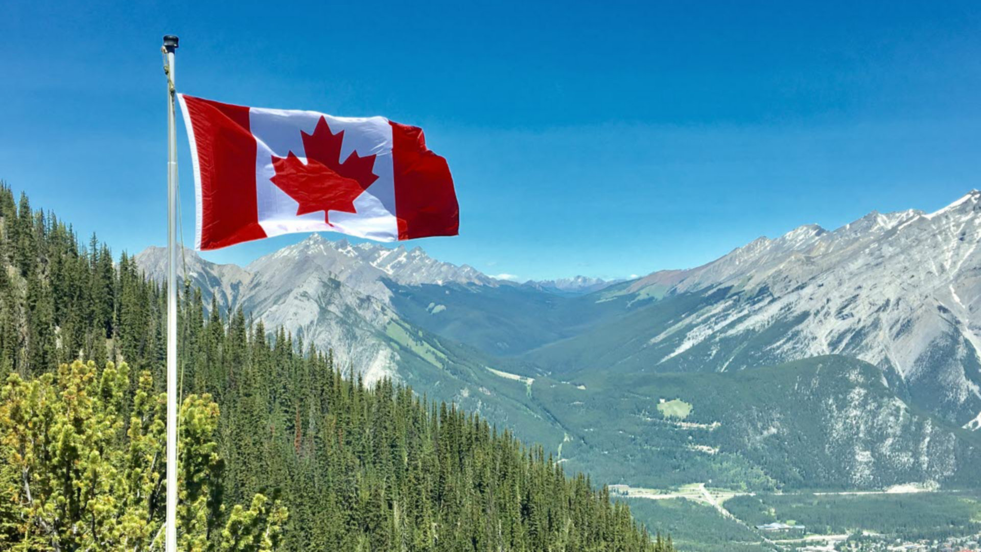 canada-flag-with-mountain-range-view