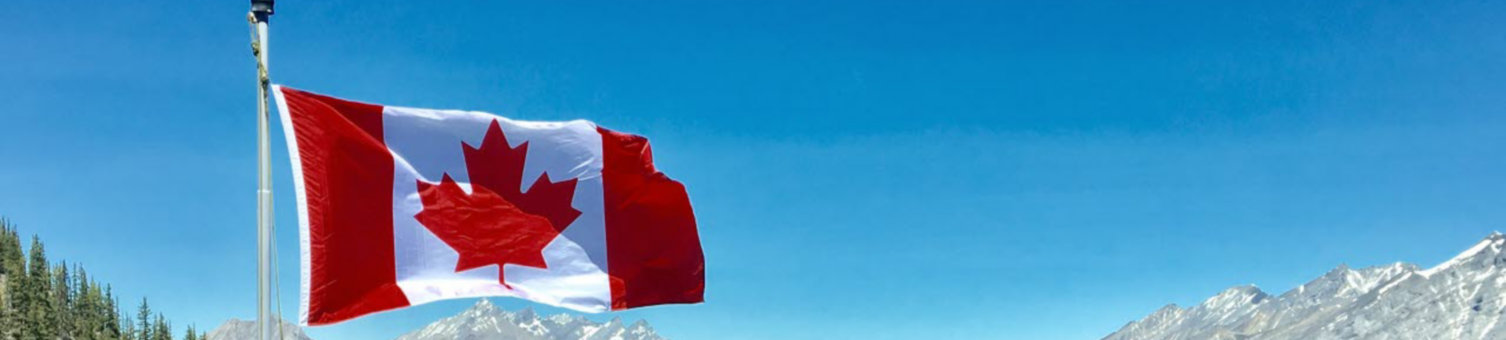 canada-flag-with-mountain-range-view