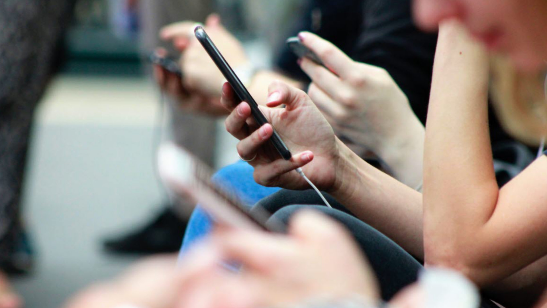 Commuters with mobile phones